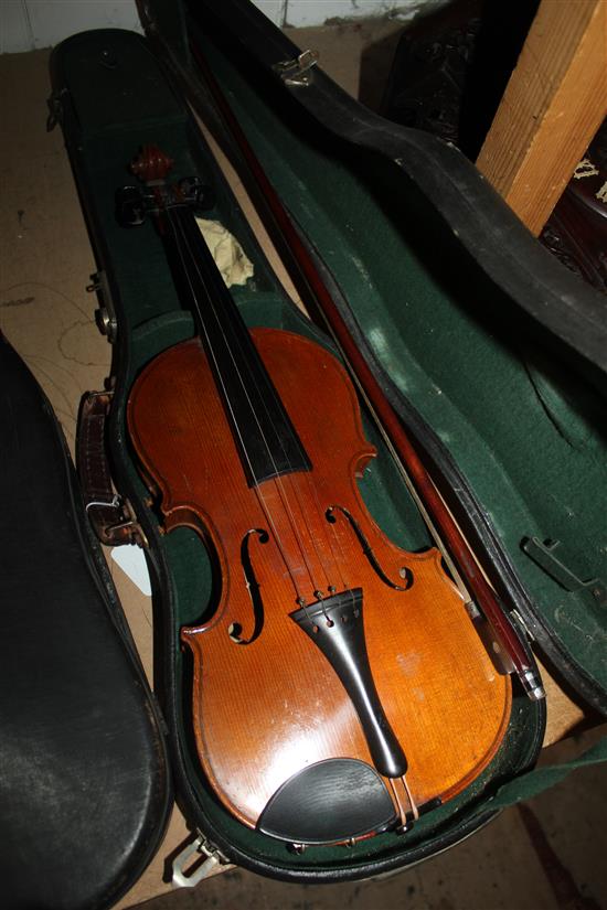 Cased violin and a mahogany bow